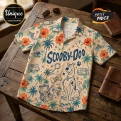 Scooby-Doo print tropical button-up shirt featuring palm trees, hibiscus flowers, and mystery machine icons on tan fabric.!