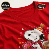 Snoopy wearing an orange party hat, holding a pink frosted donut and iced coffee on a bright red cotton crewneck t-shirt.!