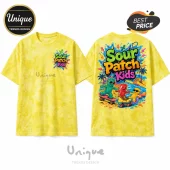 Yellow tie-dye t-shirt featuring Sour Patch Kids logo and cartoon gummies skateboarding and rollerblading on beach.!
