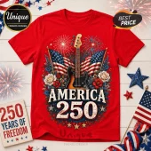 Red cotton t-shirt featuring a bass guitar, American flags, fireworks, and text reading America 250 on a wooden table.!