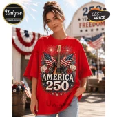 Red oversized t-shirt featuring a guitar graphic, American flags, fireworks, and the text America 250 with stars.!
