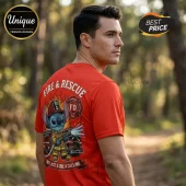 Man wearing a red crew-neck t-shirt featuring a cartoon alien firefighter graphic and text Fire and Rescue, Not Just a Job.!
