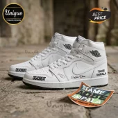 White high-top sneakers with Tame Impala and Deadbeat black text, Nike Air branding, and custom script on stone background.!
