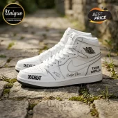 Custom white leather high-top sneakers with black text DEADBEAT and TAME IMPALA on a cobblestone background.!