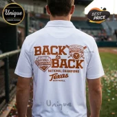 White polo shirt back view with brown Texas Softball Back to Back National Champions graphic on a blurred baseball field.!