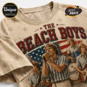 Vintage style beige t-shirt featuring The Beach Boys band members, US flag background, and red collegiate lettering.!