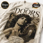 Cream colored t-shirt featuring a black and gold graphic of Jim Morrison with The Doors text and gothic archway art.!