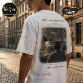White oversized t-shirt featuring back graphic of a man monitoring audio equipment with text The Lives of Others.!