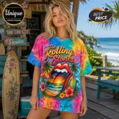 Woman wearing oversized tie-dye t-shirt with Rolling Stones logo, tropical sunset beach graphic, and hibiscus flowers.!