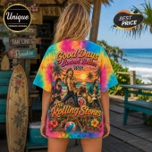 Woman wearing a tie-dye Rolling Stones graphic t-shirt featuring band members, tropical beach scenery, and hibiscus flowers.!