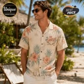 Man wearing a cream-colored short-sleeve button-down shirt featuring floral patterns and The Sandlot baseball logo.!