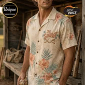 Man wearing a cream-colored short-sleeve button-down shirt with a tropical hibiscus floral print and Sandlot baseball logo.!