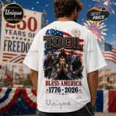 White t-shirt showing the band Tool against an American flag background with text Bless America 1776-2026 and fireworks.!
