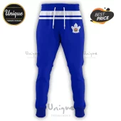 Blue athletic joggers featuring a white waistband with horizontal blue stripes and a maple leaf logo with a gold crown.!