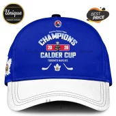 Blue and white Toronto Marlies cap with 2026 Calder Cup Champions graphics, hockey sticks, and a maple leaf logo.!