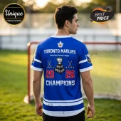 Toronto Marlies 2026 Champions blue hockey jersey with white stripes, maple leaf logo, trophy graphic, and text on back.!
