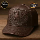Brown leather baseball cap featuring an embossed American eagle, 1776-2026, and U.S. 250th anniversary text on wooden surface.!