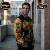 Man wearing a black and gold Wellington Hurricanes varsity jacket with 2026 Super Rugby Pacific championship embroidery.!