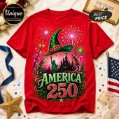 Red cotton crew neck t-shirt featuring a green wizard hat, Statue of Liberty, castle, fireworks, and America 250 text.!