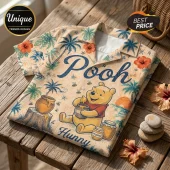 Winnie the Pooh Hawaiian shirt with tropical floral patterns, palm trees, honey pots, and blue text on a beige background.!