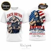 White crew neck t-shirt displaying Zach Bryan playing acoustic guitar with patriotic American flag graphics and text.!