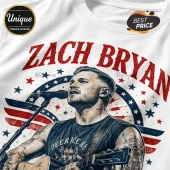 Zach Bryan white t-shirt featuring a stylized illustration of the singer with a guitar, red and blue stars, and flag.!