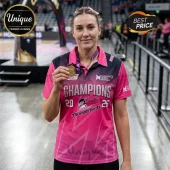 Adelaide Thunderbirds netball player wearing a pink jersey with Champions 2026 text and holding a gold medal.!