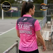 Woman wearing a pink and black Adelaide Thunderbirds 3X Suncorp Super Netball Champions polo shirt holding a netball.!