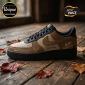 Custom brown and black leather sneaker with deer head icons, Adelaide Thunderbirds logo, and Your Name text on wood floor.!