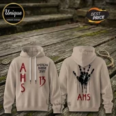 Tan hooded sweatshirt featuring red American Horror Story AHS text and a black dripping handprint design on the back.!
