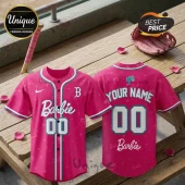 Barbie x Boston Red Sox pink baseball jersey featuring white lettering, number 00, star patterns, and team branding.