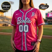Barbie x Boston Red Sox pink baseball jersey with white script text, number 00, teal trim, and star patterns on a field.