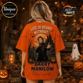 Barry Manilow Life Is Scary Without Halloween T-Shirt in orange featuring a spooky castle, pumpkins, and musical motifs.