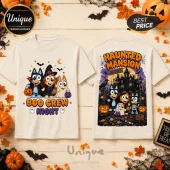 Bluey Boo Crew Halloween T-Shirt with cartoon dog characters in costumes on a light cream fabric background.