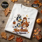 Bluey Family Too Cute To Spook Halloween T-Shirt featuring cartoon dogs in ghost and pumpkin costumes on white fabric.