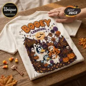 Bluey Family Too Cute To Spook Halloween T-Shirt featuring cartoon dogs in costumes at a spooky carnival with pumpkins.