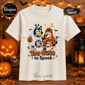 Bluey Family Too Cute To Spook Halloween T-Shirt featuring cartoon dogs in ghost and pumpkin costumes on cream fabric.