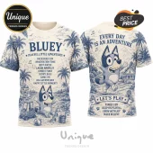 Bluey Playful Adventures Special Edition T-Shirt featuring blue line art of Bluey, palm trees, and quotes on cream fabric.