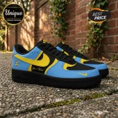 Custom basketball sneakers in black, sky blue, and yellow leather with personalized name text on a brick wall background.!