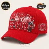 Coca Cola 140th Anniversary red baseball cap featuring a beverage bottle, cup, and fireworks graphic on the front panel.