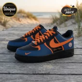 Custom Nike Air Force 1 sneakers in blue, black, and orange with personalized name script and sun logo on wooden boardwalk.!