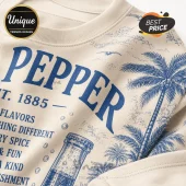 Dr Pepper Vintage Logo Blue Limited Edition T-Shirt featuring blue tropical palm tree graphics on a beige fabric base.
