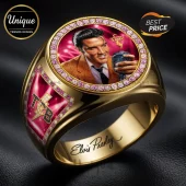 Gold Elvis Presley championship ring featuring a portrait, pink stones, and TCB lightning bolt logo on a black background.!