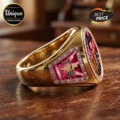 Gold Elvis Presley signet ring featuring a TCB logo on pink enamel with pink gems and a cameo portrait on a wood surface.!
