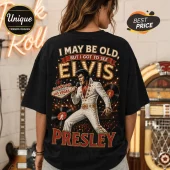 Elvis Presley Vintage Las Vegas Concert T-Shirt on a person, black cotton shirt with graphic of Elvis on stage and text.