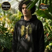 Man wearing a black cotton hoodie with a surrealist graphic of a human head replaced by a flowering plant and FKJ text.!