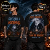 Godzilla vs Kong Halloween 2026 black t-shirt featuring kaiju silhouettes, glowing jack-o'-lanterns, and a full moon.