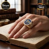 Gold Harry Potter signet ring featuring Hogwarts castle on blue enamel with diamond-encrusted bezel on a hand.!