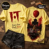 Yellow cotton t-shirts featuring Pennywise from IT, red balloon graphic, and text Every Fear Floats Back on wood background.!