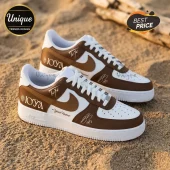 Custom brown and white leather sneakers with Joya text, signature detailing, and Your Name placeholder on sandy ground.!